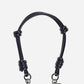 Petra Karthaus black vegan leather knotted wristlet phone lanyard with silver hardware and logo charm.