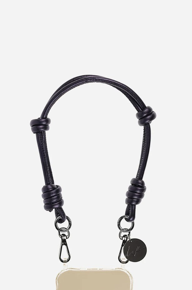 Petra Karthaus black vegan leather knotted wristlet phone lanyard with silver hardware and logo charm.