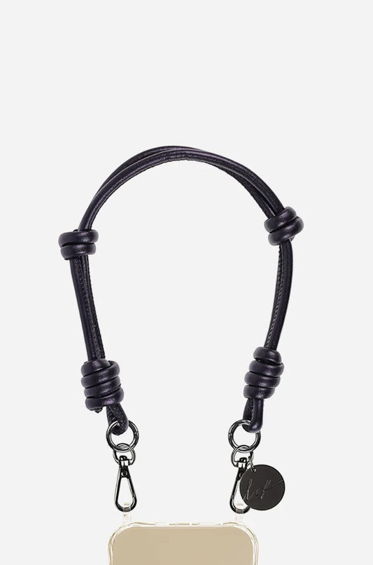Petra Karthaus black vegan leather knotted wristlet phone lanyard with silver hardware and logo charm.